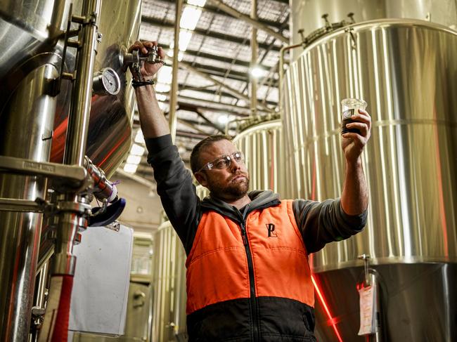 Head of Brewing Operations at Pirate Life Brewing, Lewis Maschmedt checking beer in the cellar stainless steel tanks. Photo: Mike Burton