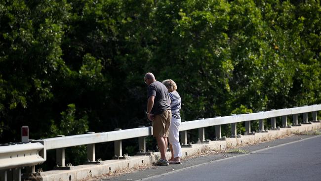 Tourists stop to inspect the residents crocodiles on the Mowbray River bridge. PICTURE: STEWART McLEAN