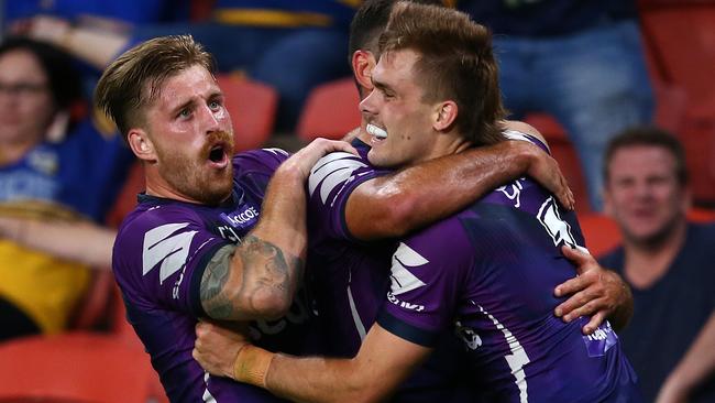 BRISBANE, AUSTRALIA - OCTOBER 03: Cameron Munster and Ryan Papenhuyzen of the Storm celebrate a try during the NRL Qualifying Final match between the Melbourne Storm and the Parramatta Eels at Suncorp Stadium on October 03, 2020 in Brisbane, Australia. (Photo by Jono Searle/Getty Images)