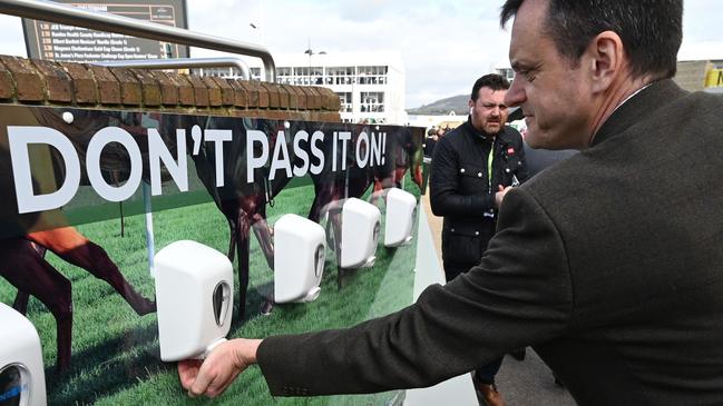 A man uses a hand sanitiser at this month’s Cheltenham Festival horse racing meeting in England. Picture: AFP