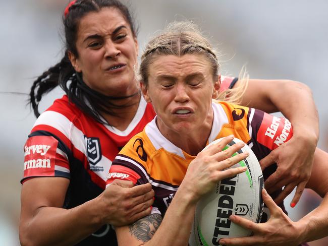 Broncos Julia Robinson is tackled by Roosters Yasmin Meakes during the Roosters v Broncos Women's Premiership match at ANZ Stadium, Homebush. Picture: Brett Costello