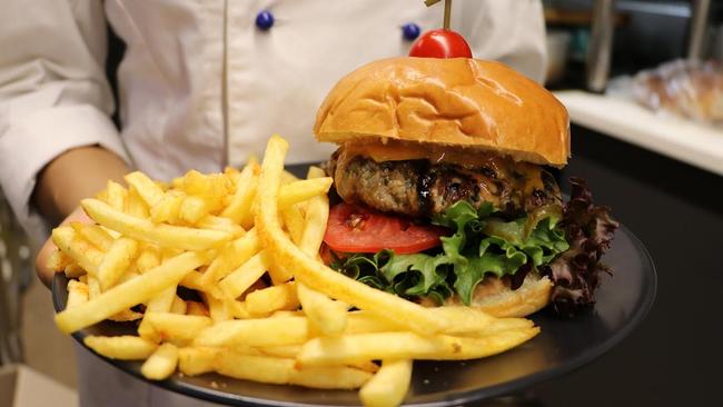 Mint Fresh's Straya burger features a house-made beef pattie with Jarlsberg cheese, beetroot relish, tomato, pickles, cos lettuce, mayo and house-made BBQ sauce, served with seasoned fries ($17). Picture: Mint Fresh IGA &amp; Cafe