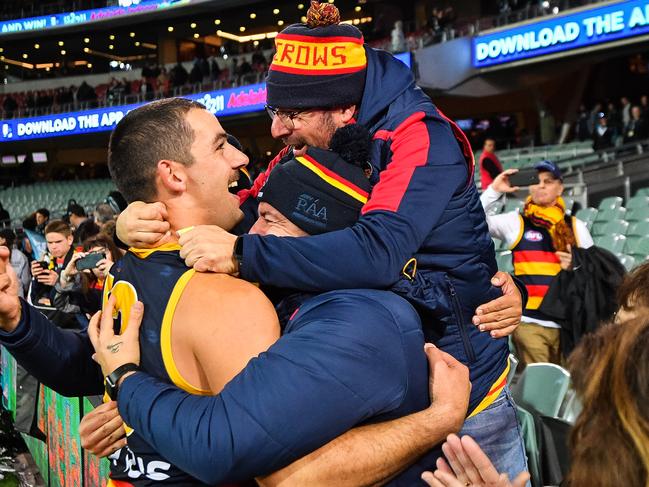 Crows co-captain Taylor Walker celebrates with fans after his side’s round eight win over Port Adelaide at Adelaide Oval in May. Picture: Daniel Kalisz/Getty Images