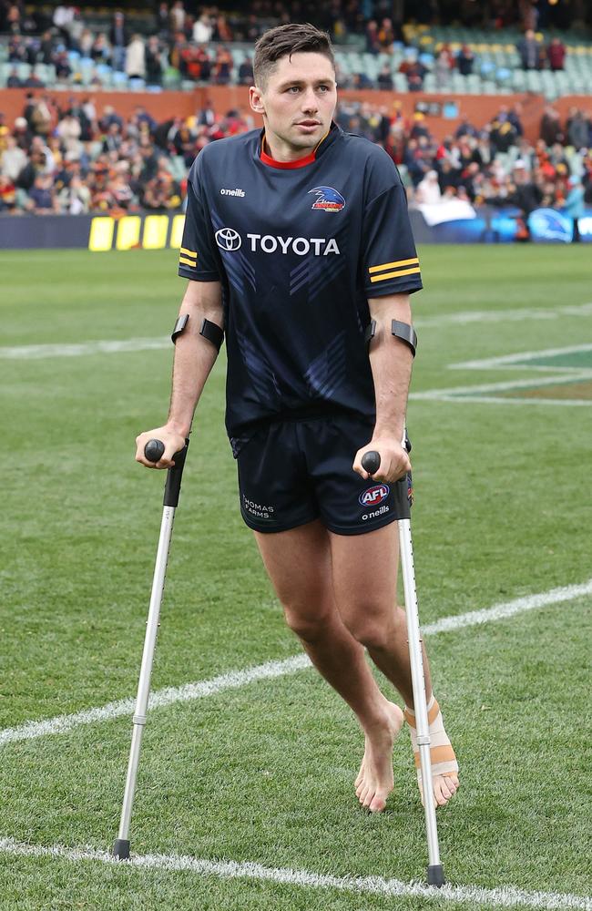 Jones on crutches after injuring his foot. Picture: Sarah Reed/AFL Photos