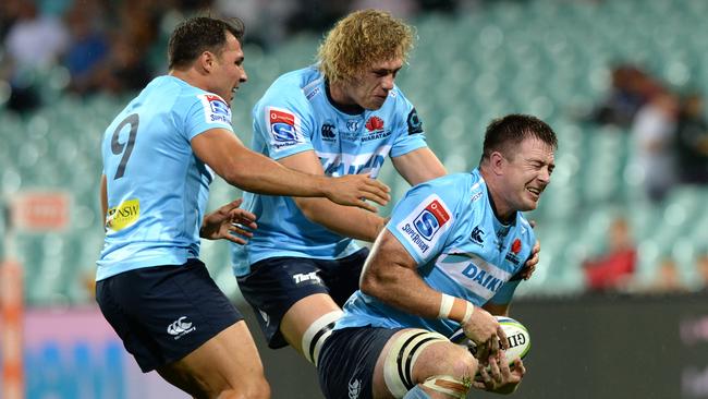 Jed Holloway (right) scores for the Waratahs.