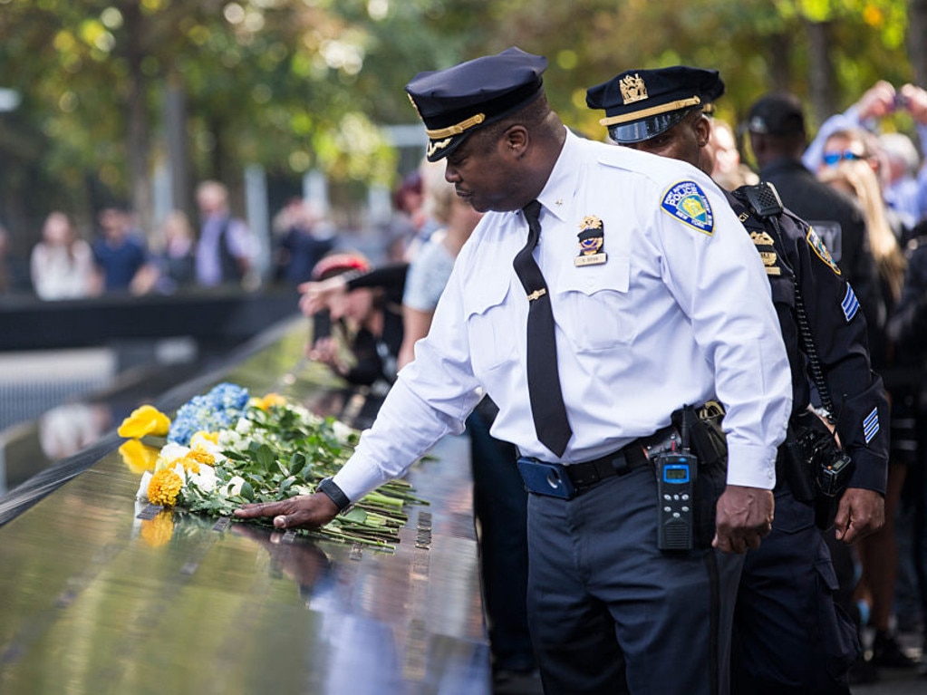 Law enforcement officials lay flowers in tribute to slain New York Police Department officer Randolph Holder at National September 11th Memorial on October 22, 2015. Picture: Andrew Burton/Getty Images