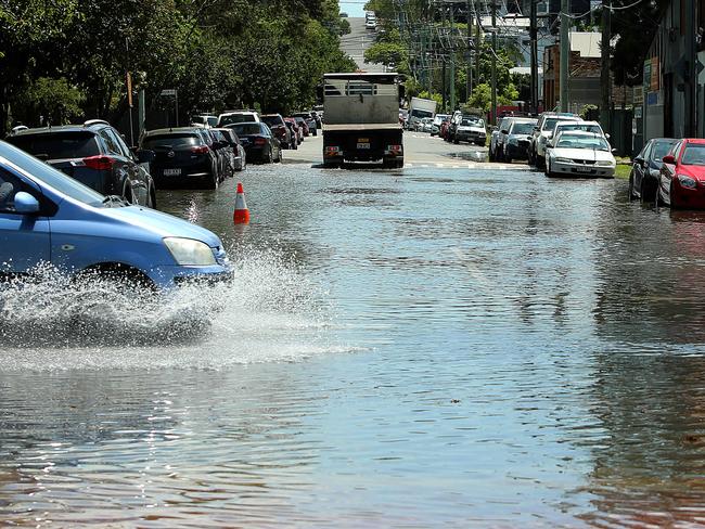 Northey Street Windsor, during local flooding from Enoggera Creek, Brisbane, Wednesday, February 20, 2019. Locals need a new flood mitigation plan for Enoggera Creek and Breakfast Creek. (AAP Image/Jono Searle)