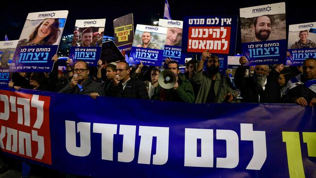 Right wing Israelis hold images of fallen soldiers during a march in Jerusalem rejecting a potential deal with Hamas. Picture: AFP