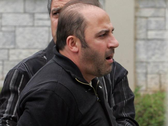 Tony Mokbel is transferred to a jail in Athens in 2008 prior to his extradition to Australia. Picture: Tim Anderson