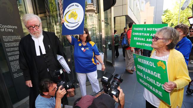 Robert Richter QC, lawyer for George Pell, is surrounded by protesters outside court. Picture: Michael Dodge/Getty Images