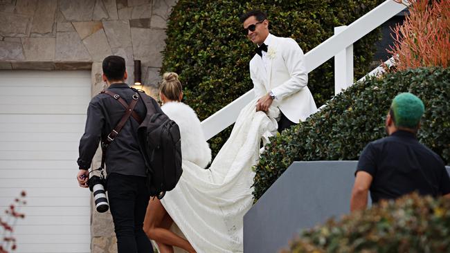 Jimmy helps his bride down the stairs. Picture: Adam Yip