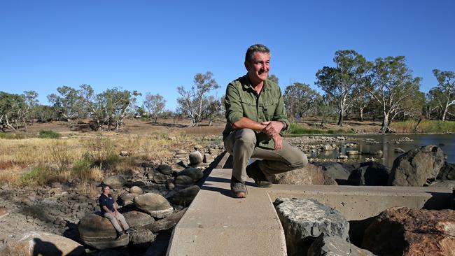 Daily Telegraph journalists Tim Blair (L) and Warren Brown (R) walk along the weir of the Barwon River at Brewarrina that feeds into the Darling River. Picture: Toby Zerna