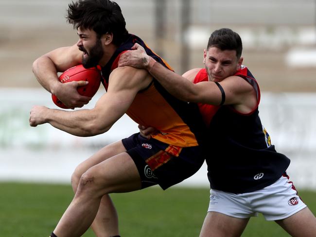 Dion Hill of EK is tackled byTimothy Barresi of Tulla during the EDFL Division 1 footballmatch between East Keilor and Tullamarine played at Coburg City Oval on Saturday 7th September, 2019.