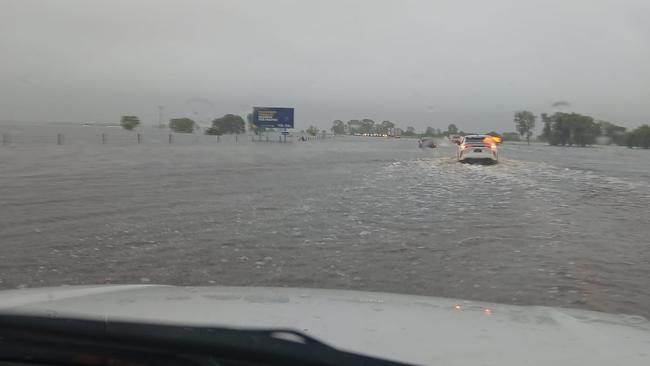 The Bruce Highway has flooded in the Whitsundays, with cars stopped in floodwaters near Goorganga. Photo: CJ Magee