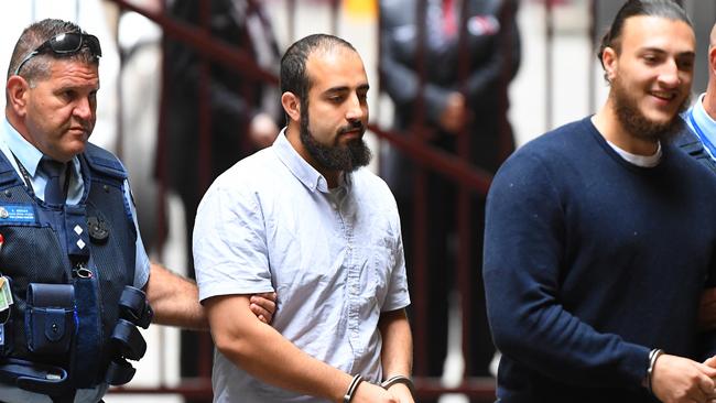 Hamza Abbas (centre) arrives at the Supreme Court of Victoria during his long running trial.