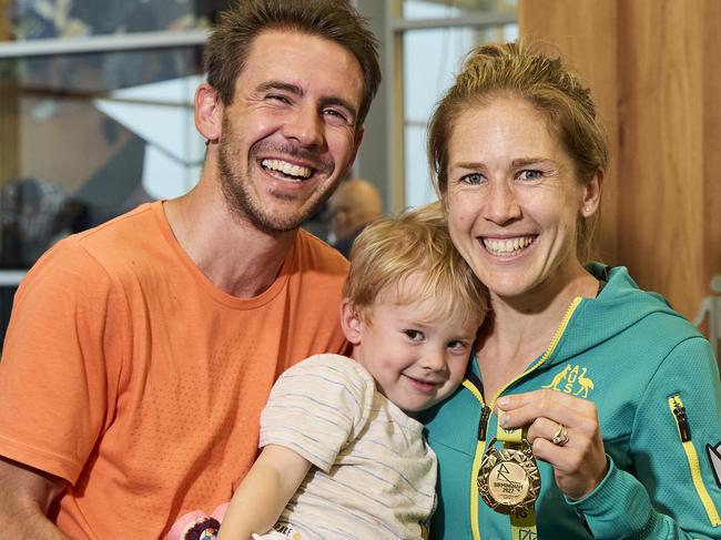 Dylan Stenson, Billy Stenson, 2, and Jess Stenson with her gold medal from the Commonwealth Games at Adelaide Airport, Friday, Aug. 5, 2022. Picture: MATT LOXTON