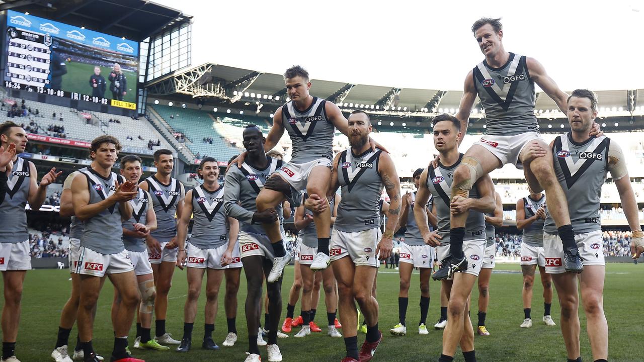 Bittersweet milestones as Ollie Wines (left) and Tom Jonas are chaired off after playing their 200th games. Picture: Daniel Pockett/Getty Images