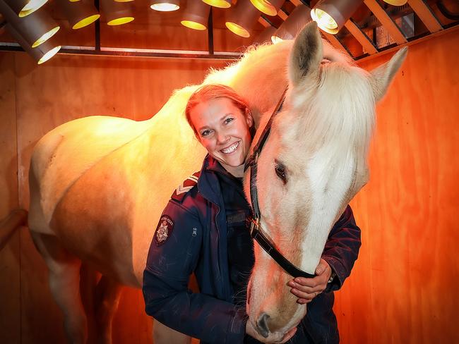 A member cuddles up with Clifford under the heat lamps. Picture: Ian Currie