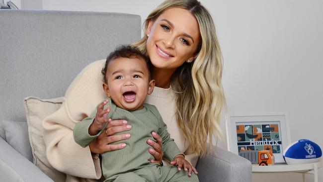 Emily McKay, partner of North Melbourne player Majak Daw, with their baby son Hendrix. Picture: Nicki Connolly