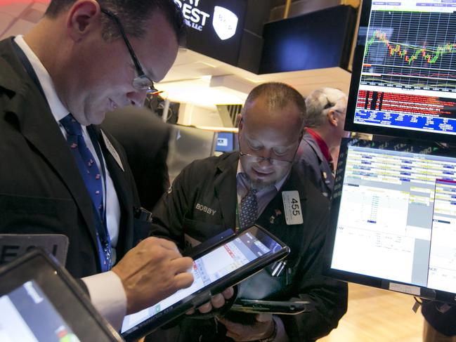 FILE - In this Oct. 2, 2015 file photo, traders Edward Curran, left, and Robert Arciero work on the floor of the New York Stock Exchange. The markets have rallied since late September. Investors were relieved when the Federal Reserve held off on raising interest rates in September and many now expect rates won’t go up this year. (AP Photo/Richard Drew, File)