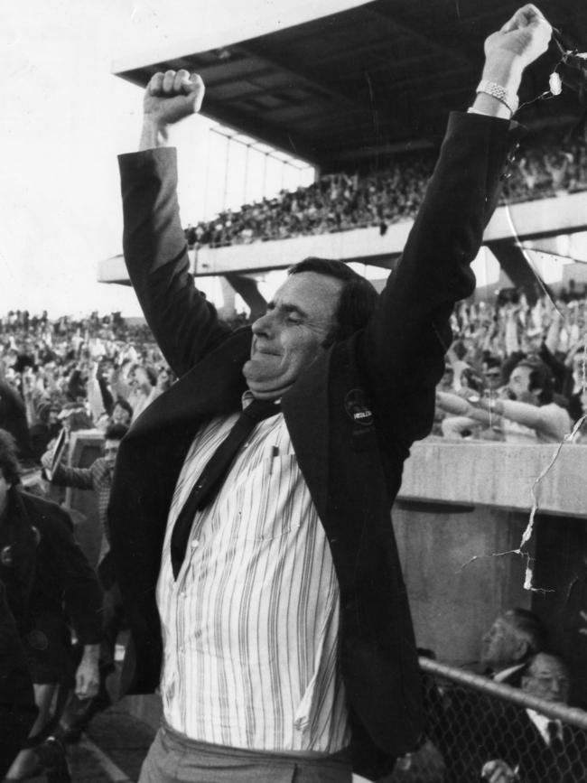 Norwood coach Bob Hammond raises his arms in triumph after the win.