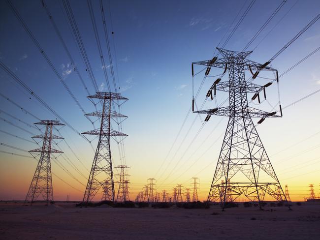 Power cables going in to the distance at dusk.