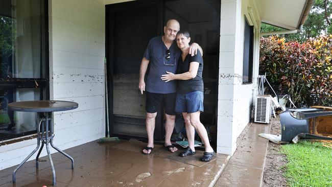 Ted Fay and Pam Fay console each other as they walk into their Clitheroe Street home. Picture: Brendan Radke