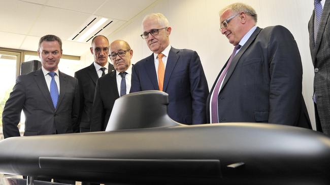 Christopher Pyne, left, Jean-Yves Le Drian third from left, and Malcolm Turnbull at the opening of the French shipbuilder DCNS in Adelaide in 2016. Pic: AAP