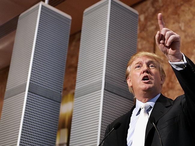 Real estate developer Donald Trump holds a news conference at Trump Tower in New York 18 May, 2005, standing next to a nine-foot model of his proposed Twin Towers II, an alternative to the Freedom Tower design that was approved by the city to be built on Ground Zero. Trump's "redesign" would be rebuilt on the original site, only stronger and a floor higher than the Twin Towers destroyed 11 September, 2001.   AFP PHOTO  Timothy A. CLARY