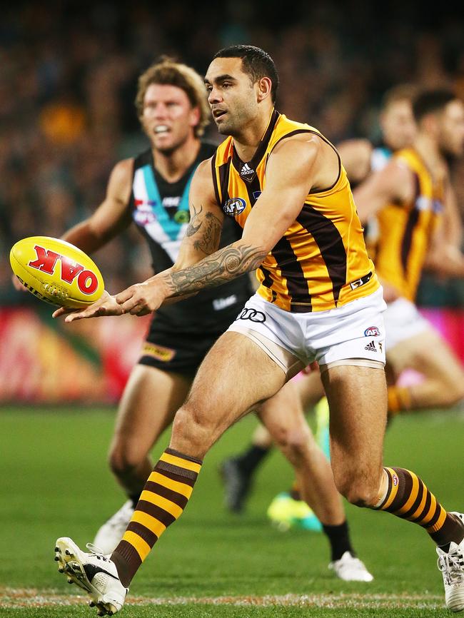 Shaun Burgoyne fires off a handball in front of Port Adelaide’s Brad Ebert. Picture: Morne de Klerk/Getty Images