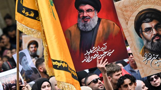 Demonstrators hold flags and pictures of Hezbollah terror-group leader Hassan Nasrallah at a protest rally in central Sydney on September 29.