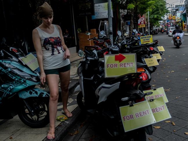 A foreigner tourist is looking for a rental motorcycle in Seminyak, Bali, Indonesia. Picture: Getty Images