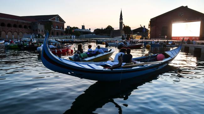 People watch the film The Prestige from from gondolas and other boats at the Barch-in in Venice. Picture: AFP