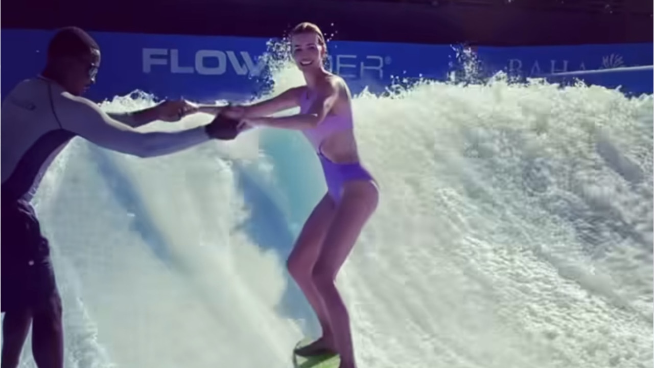 Ivanka Trump tumbles while surfing in purple swimsuit