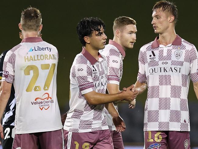 SYDNEY, AUSTRALIA - NOVEMBER 30: Jacob Brazete of the Roar and Thomas Waddingham of the Roar embrace following the round six A-League Men match between Macarthur FC and Brisbane Roar at Campbelltown Stadium, on November 30, 2024, in Sydney, Australia. (Photo by Cameron Spencer/Getty Images)