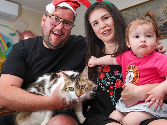 MELBOURNE, AUSTRALIA -  DECEMBER 23 2023  Kate Swanson, Luke Milroy, their cat John Snow and daughter Murphy.Katie Swanson and Luke Milroy are celebrating a Christmas miracle after their cat showed up 120 kilometres away after two years of being lost.Picture: Brendan Beckett