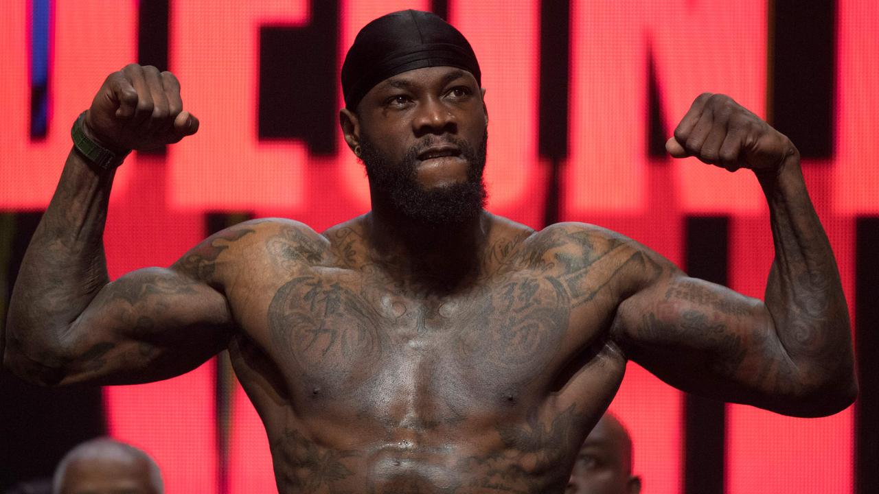 Deontay Wilder flexes during his official weigh-in.