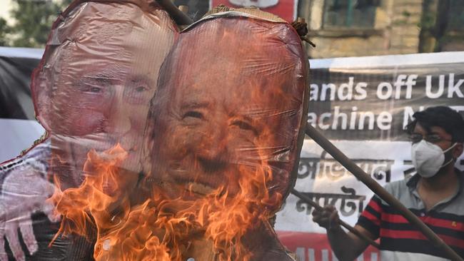 Leftist activists of Socialist Unity Centre of India (Communist) or SUCI burn effigies of Russian president Vladimir Putin (L) and US president Joe Biden embracing as they protest against the Russian invasion in Ukraine. Picture: AFP