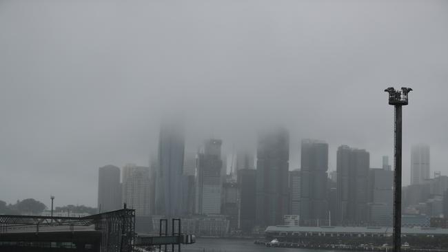 The rain stopped and gave way to fog settling over Sydney on Friday morning. Picture: John Grainger