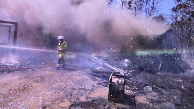 Redlands residents are being urged to have an emergency plan in place as bushfires continue to affect Australia. Here, a firefighter walks past a shed that was lost to previous fires in Redlands’ semirural suburb of Mount Cotton late last year. PICTURE: AAP/Richard Gosling