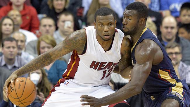 Miami Heat's Shawn Young drives through the defence of New Orleans Pelicans' Patric Young.