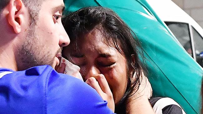 An injured Juventus fan is comforted after the stampede.