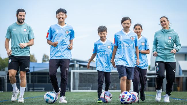 Melbourne City‘s Mat Leckie and former Matildas captain and City goalkeeper Melissa Barbieri with Omid Hasani (12), Umeed Haidri (11), Hannah Nguyen (11) and Yalda Ehsani (12). Picture: Jake Nowakowski