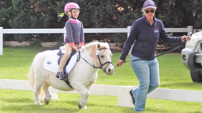 Grace McOwn and her Mini pony Indi were a popular winner at the Australian Pony Dressage event. Grace is led by her mum, Nicole. Picture: Fran Cleland