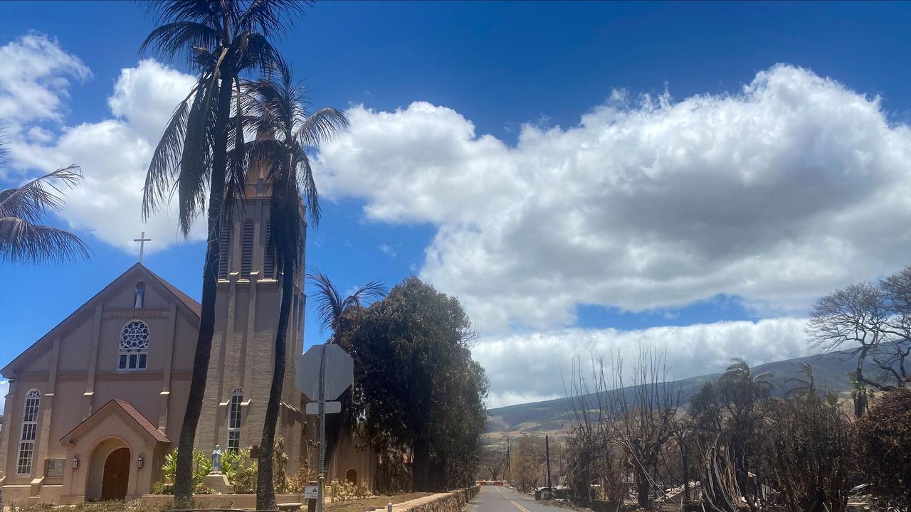 Burned houses are seen adjacent of Maria Lanakila Catholic Church, on Waine Street, in the aftermath of a wildfire in Lahaina. (Photo by Paula RAMON / AFP)