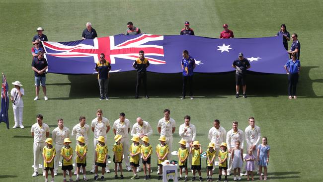 The Australian players line up for a tribute to Shane Warne before the game. Picture: David Caird