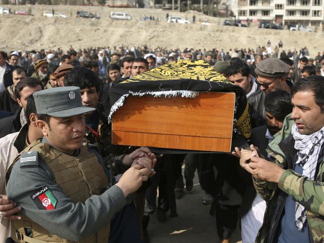 Men carry the coffin of a relative who died in Saturday's deadly suicide attack in Kabul, Afghanistan, Sunday, Jan. 28, 2018. The deadly explosion caused by a suicide bomber driving an ambulance in the capital. (AP Photo/Rahmat Gul)