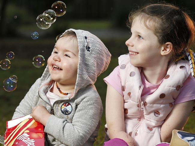 Carrie Giles, 2, and Mia Wilkinson, 7, posing at Kallangur, Brisbane 25th of June 2020.  Mia and Carrie both lost their limbs due to complications with Sepsis.  (Image/Josh Woning)