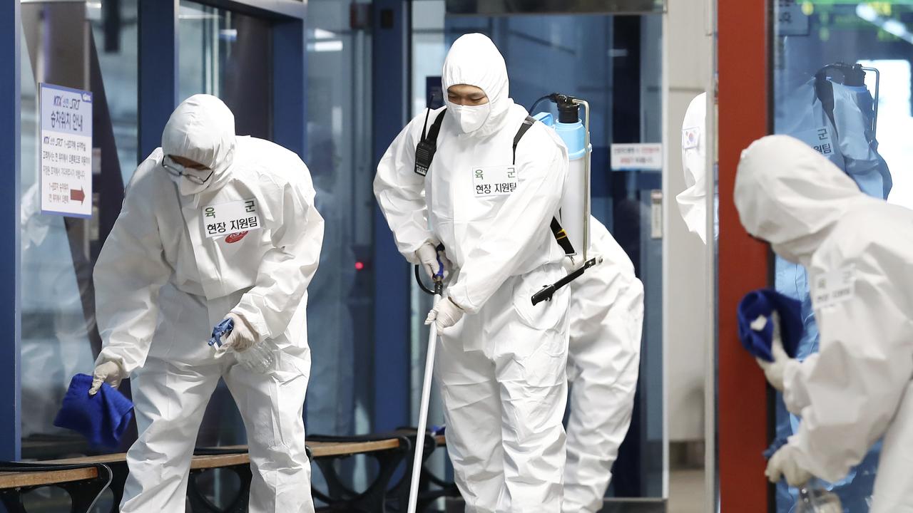 South Korean soldiers wearing protective gear disinfect a train station in Daejeon, South Korea. Picture: Kim Jun-beom/Yonhap via AP.