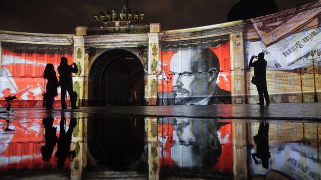 People look at an illuminated portrait of Lenin in St Petersburg. Picture: AP